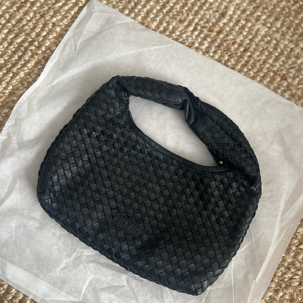 Leather woven black handbag in the style of Bott ega.